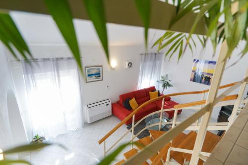 ein Wohnzimmer mit einem roten Sofa und einer Treppe in der Unterkunft Villa Sanda with Private Pool in Zadar