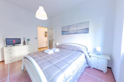 a white bedroom with a bed and a tv at [Vista Mare Portofino] Terrazza • Free Parking • Wi-fi in Rapallo