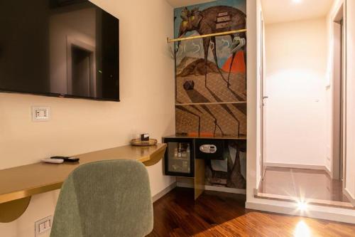 a home office with a desk and a television at Bhr Cavour 150 in Rome