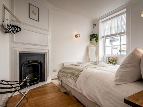 a bedroom with a bed and a fireplace at Pass the Keys Stylish and bright City Centre apartment in Exeter