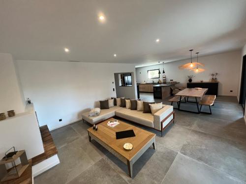 a living room with a couch and a table at Villa bord de mer in Hyères