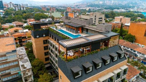 an aerial view of a building with a swimming pool at Landmark Hotel in Medellín