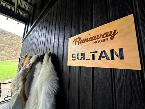 a sign on the side of a barn with a horse at Runaway House - Qalacıq in Gabala