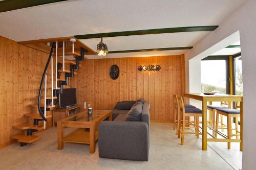 a living room with a couch and a staircase at Haus Gieselsberg, mit Aussicht auf Schmalkalden in Schmalkalden