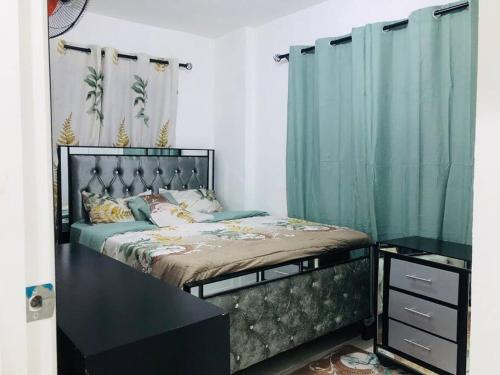 a bedroom with a large bed with blue curtains at Casa en Baní cerca de la playa in Baní