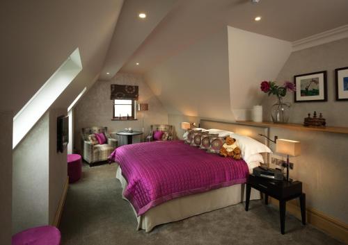 a bedroom with a purple bed in a attic at Northcote in Langho