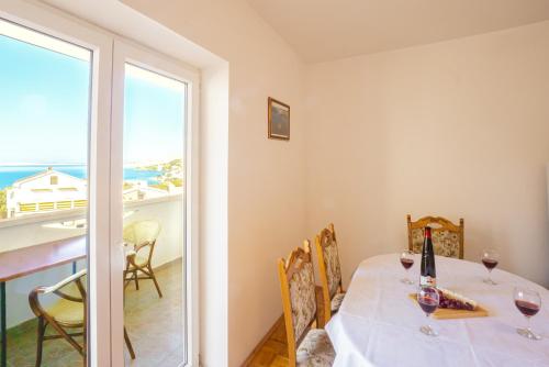 a dining room with a table and a view of the ocean at Jasko i Jelica beautiful view in Metajna