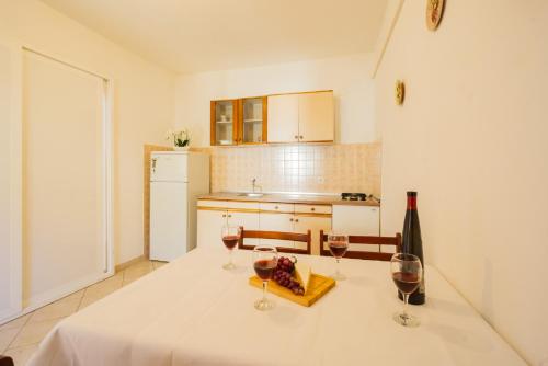 a kitchen with a table with two glasses of wine at Jasko i Jelica beautiful view in Metajna