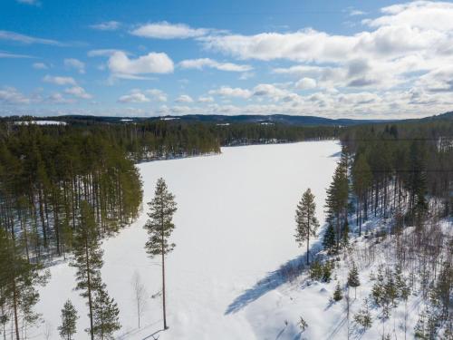 an aerial view of a snow covered field with trees at Luxury Villa Rahavaara in Joensuu