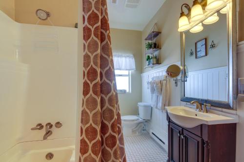 a bathroom with a tub and a sink and a toilet at Beautiful Historic Home Near Bryce Canyon! in Cannonville