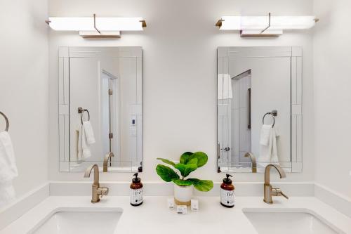 a bathroom with two sinks and two mirrors at Leisure Lodge Living in Gunnison