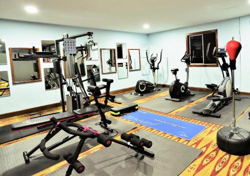 a gym with several exercise equipment in a room at Xpeed Holiday Hotel in Kuala Lumpur