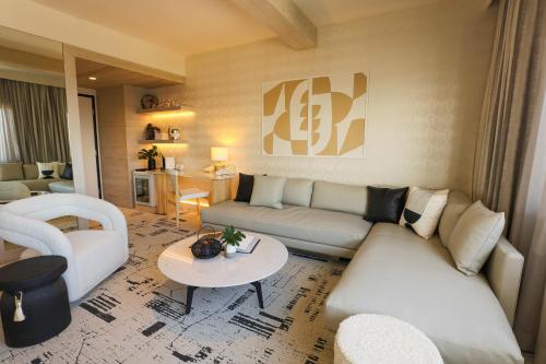 a living room with a couch and a table at Huntley Santa Monica Beach in Los Angeles