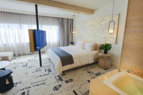a hotel room with a bed and a tv at Huntley Santa Monica Beach in Los Angeles