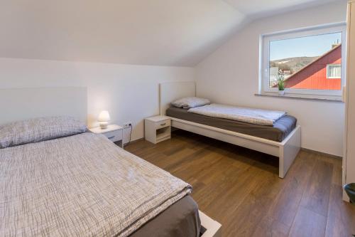 a bedroom with two beds and a window at Zeichner in Geisingen