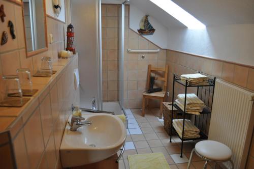 a bathroom with a sink and a toilet in it at Pension Jonas in Baar