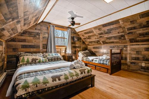 a bedroom with two beds in a log cabin at Woodland Cabin Retreat in Lake Harmony