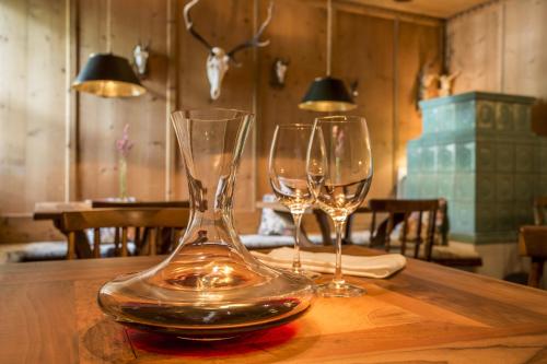 two wine glasses sitting on top of a wooden table at Theresa Wellness-Genießer-Hotel in Zell am Ziller