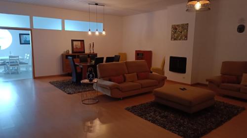 a living room with couches and a dining room at Apartamento Pérola da Vila in Vila Franca do Campo