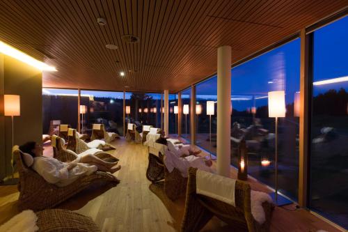 a group of people laying in chairs on a balcony at Almhotel Hochhäderich in Riefensberg