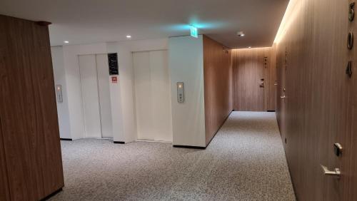 an empty hallway with white walls and wooden doors at Hotel Principe Avila in Lisbon