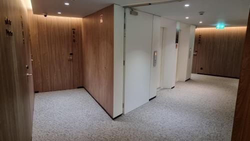 a corridor of an office with wooden walls and doors at Hotel Principe Avila in Lisbon