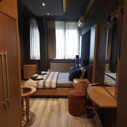 a small bedroom with a bed and a window at IN CLUB in Vrnjačka Banja
