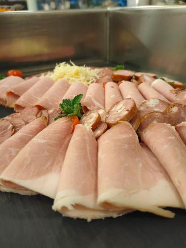 a bunch of ham and mushrooms on a table at Hotel Garni Colora in Bad Radkersburg