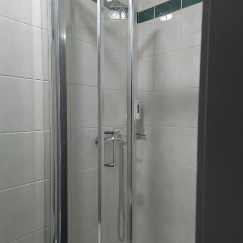 a shower with a glass door in a bathroom at IN CLUB in Vrnjačka Banja