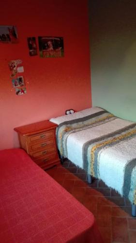 a bedroom with two beds and a wooden dresser at CORTIJO HOYA MESA in Santa Fe