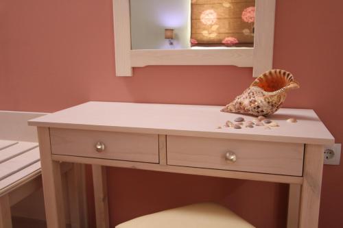a white dressing table in a room with a mirror at Naya in Kissamos