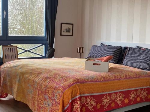 a bedroom with a bed with a laptop on it at Meer Zeit in Kirchdorf