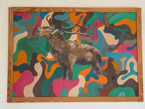 a painting of a deer on a colorful wall at Meerzeit & Ayurveda in Kirchdorf