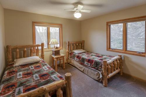 a bedroom with two beds and a window at Dog Friendly Leech Lake Home w Perfect Beach Garage Boat Lift in Walker