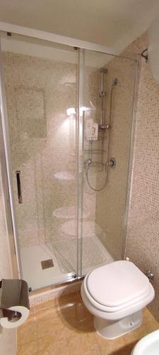 a bathroom with a shower with a toilet and a glass shower stall at "Holiday Home" casa vacanze in Salerno