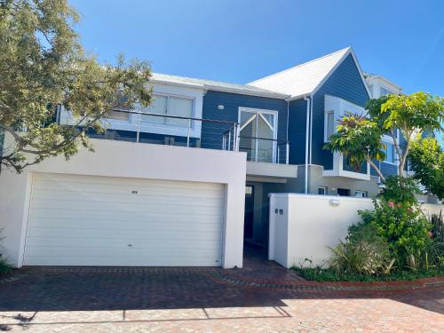 a large blue house with a white garage at 42 Spinnaker, The Quays in Knysna