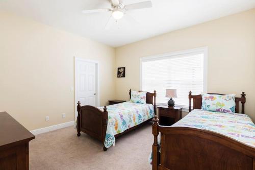 a bedroom with two beds and a window at Reunion Resort pool home with hot tub / 4 bedrooms in Kissimmee