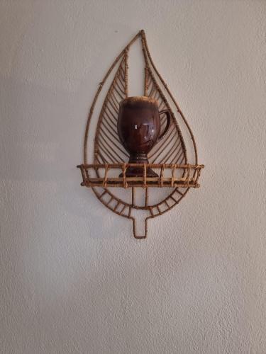 a vase is hanging on a wall at Joannes Vacation Rooms in Adamas