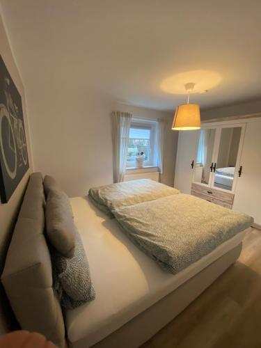a bedroom with a bed and a couch and a window at Ferienwohnung „Maya“ in Langelsheim