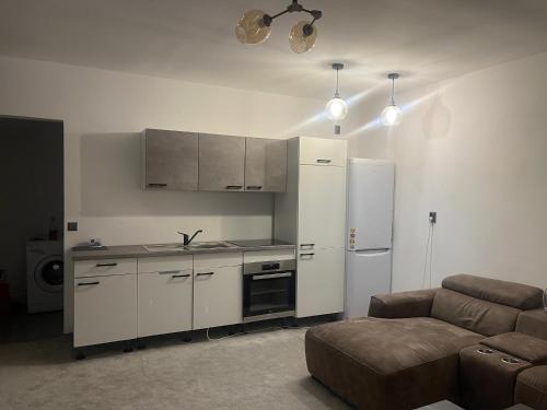 cocina con nevera y sofá en una habitación en Apartament cu scara interioară, en Floreşti
