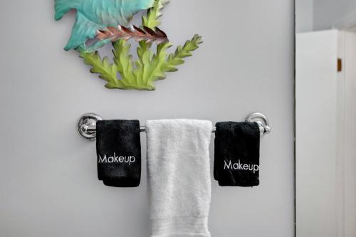 a bathroom with two towels hanging on a wall at Chic Townhouse Steps to the Beach Outdoor Pools in Panama City Beach