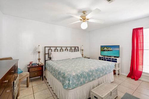 a bedroom with a bed and a ceiling fan at Chic Townhouse Steps to the Beach Outdoor Pools in Panama City Beach