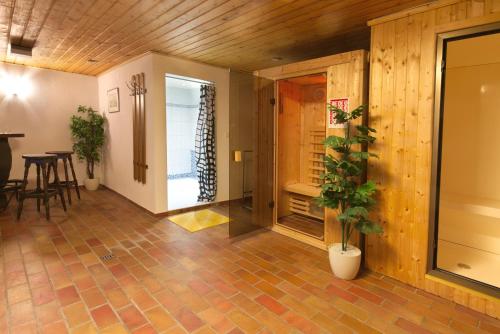 a living room with a table and a potted plant at Ostbacher Stern in Leutasch