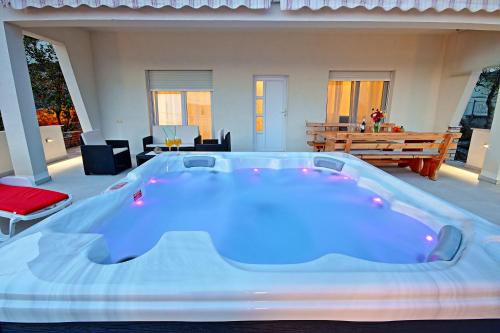 a large blue hot tub in the middle of a patio at Apartman Slavko in Seget Vranjica