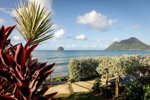 a view of the ocean from a resort at Eden Roc Villas in Le Diamant