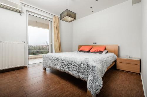 a bedroom with a bed and a large window at Villa Lara in Sparti