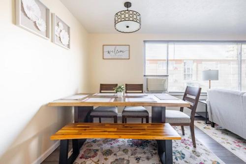 a dining room with a wooden table and chairs at King & Queen Memory Foam Beds 2-2b Georgetown Villas in Fairview Park