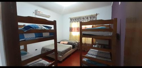 a room with two bunk beds in a room at Mi Buen Relax in Puerto Iguazú