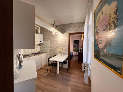 a kitchen and dining room with a table in a room at Ancient Courtyard Bonanomi in Como Historic Centre in Como
