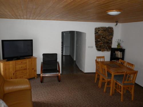 a living room with a television and a table and chairs at U Zámku in Stráž nad Nežárkou